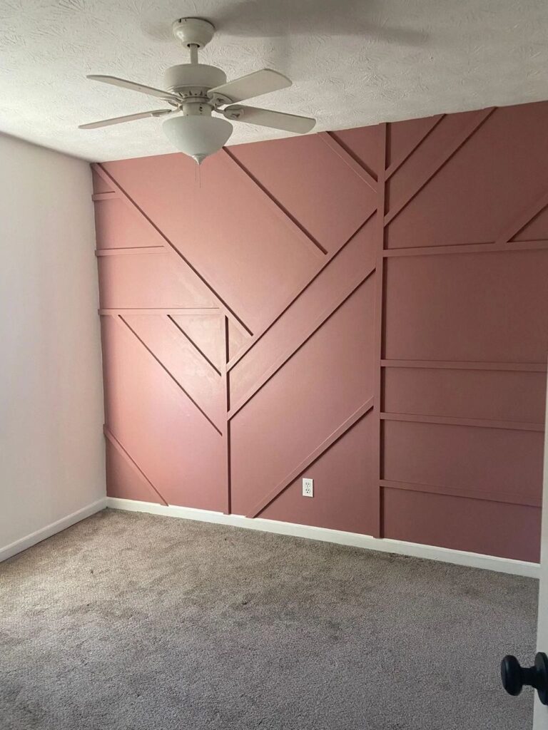 Bedroom accent wall with angled pink and mauve feature-wall paneling