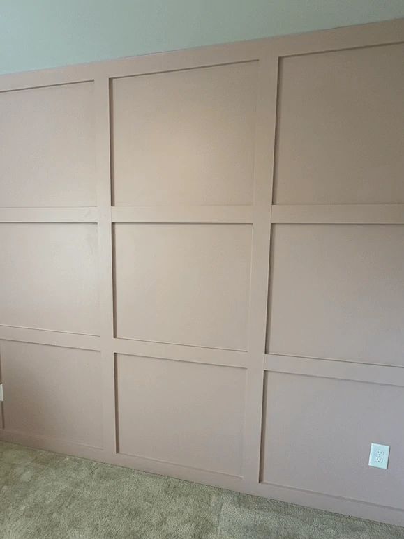 Wall with raised rectangular panel moulding painted a soft mauve