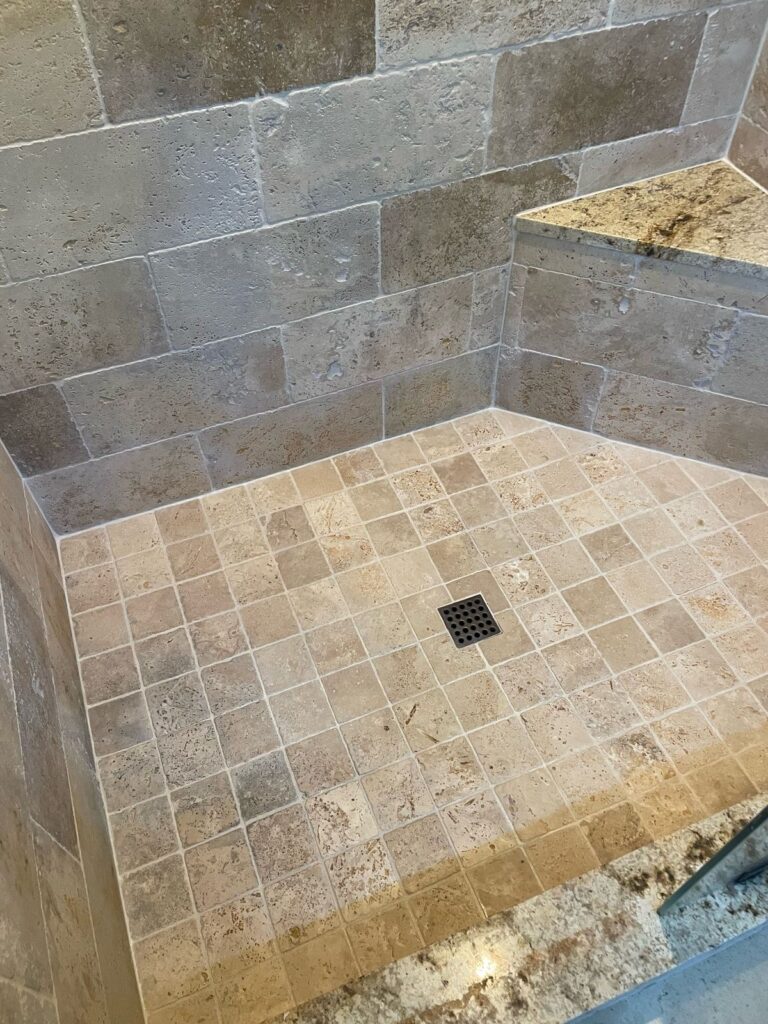 The same shower after cleaning, new corner seams and color-sealed grout lines