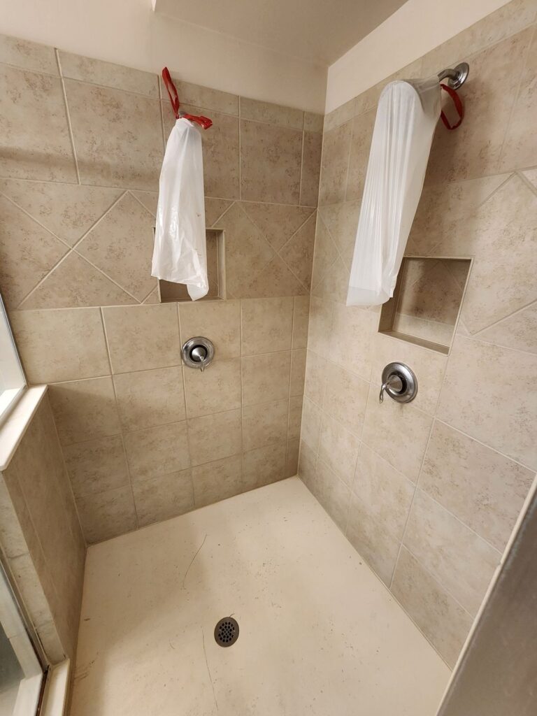 Pan-floor shower after cleaning, repaired grout and epoxy sealant
